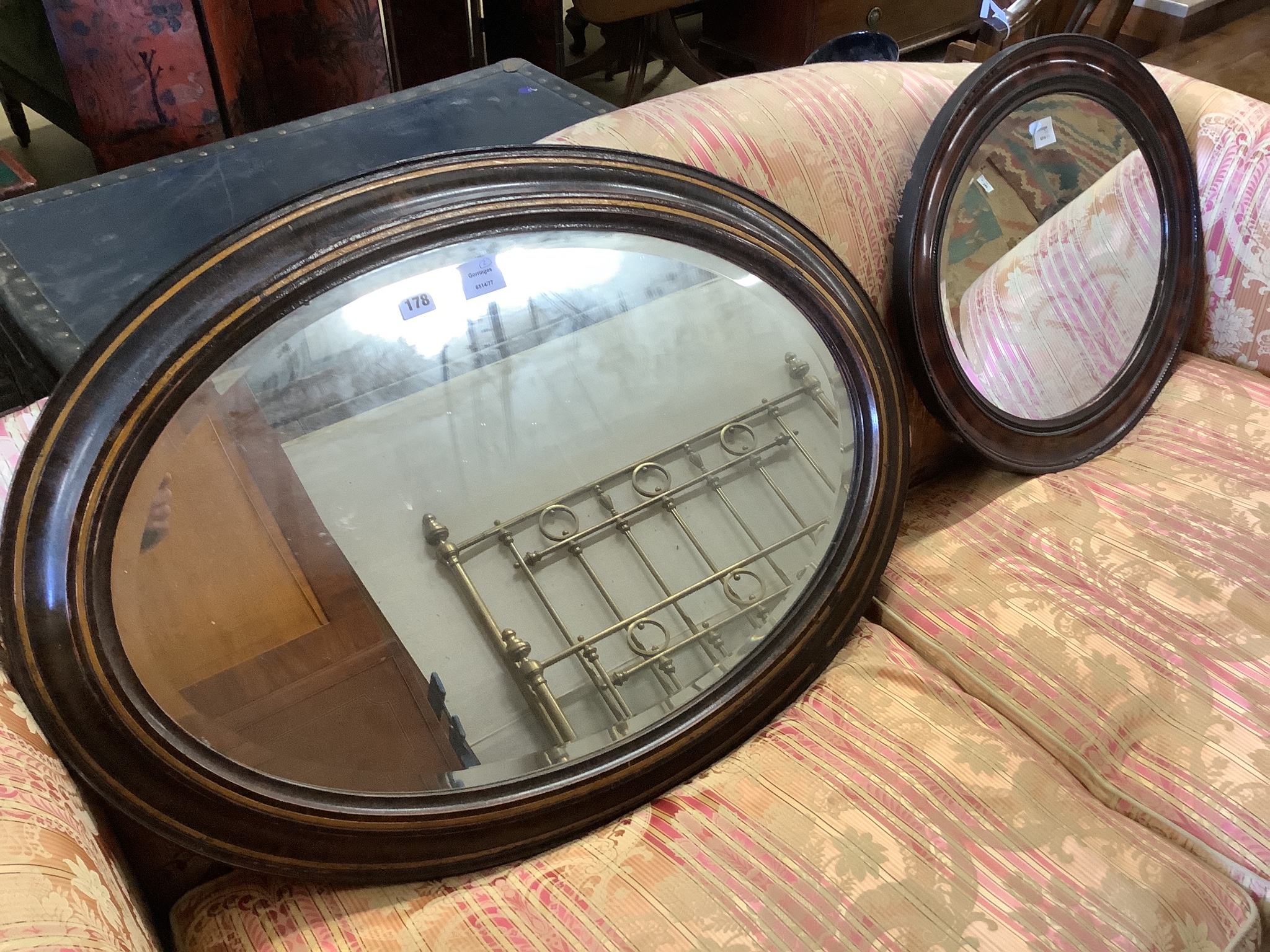 An Edwardian oval simulated tortoiseshell mirror and one other mirror, larger width 90cm, height 65cm